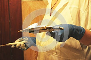 Female plasterer painter repairing a ceiling indoor