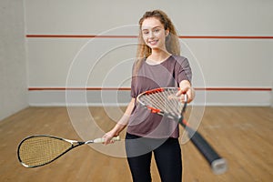 Female player gives squash racket