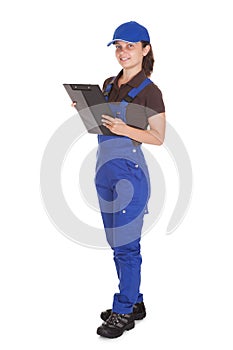 Female plumber holding clipboard
