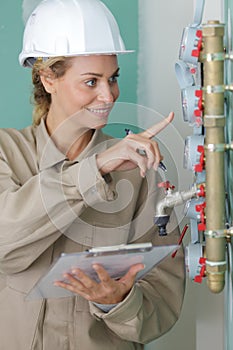 female plumber reading water meters