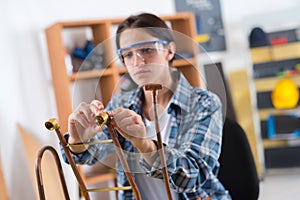 female plumber working in house with cooper pipes