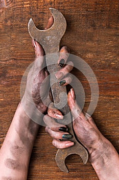 Female plumber wrench dirty hands