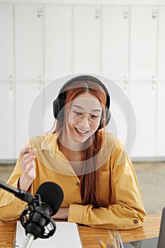 Female podcaster making audio podcast from her home studio