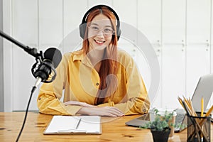 Female podcaster making audio podcast from her home studio