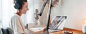 Female podcaster recording broadcasting into microphone