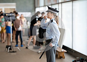 female police officer in uniform on duty during a public event