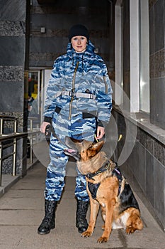 Female police officers with a trained dog. German shepherd police dog