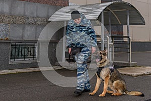 Female police officers with a trained dog. German shepherd police dog