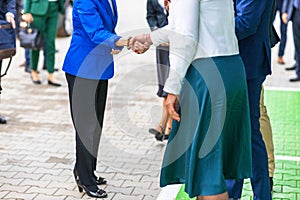 Female politicians or business persons welcome handshake before meeting