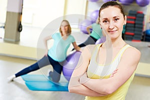 Female portrait of coach for pregnant woman doing fitness ball exercise