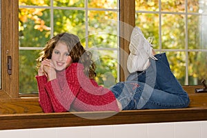 Female Portrait Lying In Window Sill photo