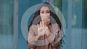 Female portrait outdoors hispanic young scared woman brunette curly stressed afraid girl feeling anxiety fear horror