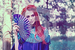 Female portrait with peacock feather on foreground. beauty makeup.