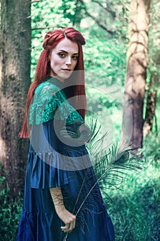 Female portrait with peacock feather on foreground. beauty makeup.