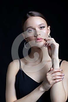 Female portrait with rhinestones makeup. Woman with earring in the form of a shiny ring in the ear