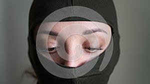 Female portrait of young girl wearing khaki balaclava, only eyes are visible, mandatory conscription, military, feminism