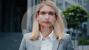 Female portrait young successful caucasian businesswoman blonde in formal suit looking at camera confident proud serious