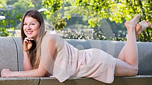 Female is posing playfully on bench in her free time