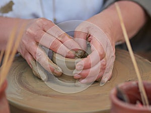 Female Potter creating a bowl on a Potters wheel