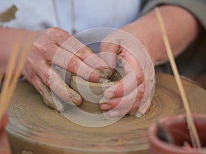 Female Potter creating a bowl on a Potters wheel photo