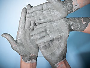 Female potter works with clay, craftsman hands close up, kneads and moistens the clay