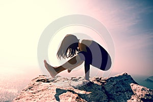 Female practicing yoga arm-balance handstand