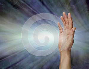 Female Pranic healer sending focused energy from right hand palm chakra photo