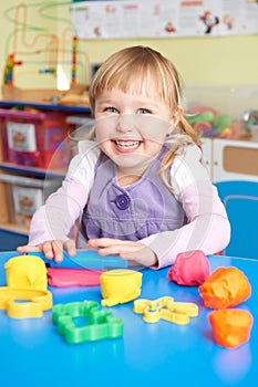 Female Pre School Pupil Playing With Modelling Clay