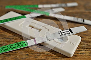 Female pregnancy test with two stripes as a positive confirmation of baby expectation