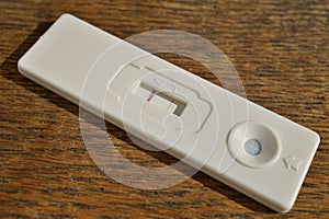 Female pregnancy test with two stripes as a positive confirmation of baby expectation