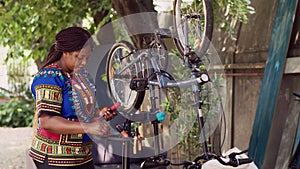 Female prepares tools for broken bicycle