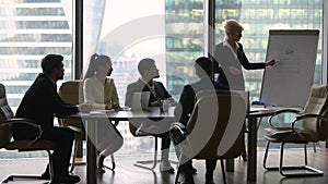 Female presenter giving lecture presentation in modern office