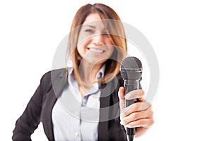 Female presenter handing over the microphone