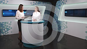 Female presenter interviewing a famous woman at tv studio