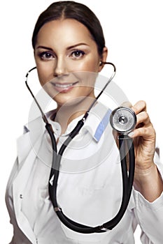 Female pretty doctor with a stethoscope listening