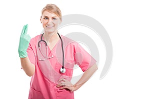 Female proctologist posing showing fingers and smiling photo