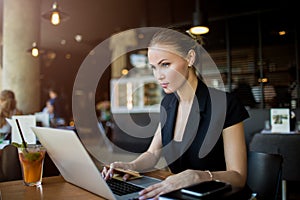 Female professional broker checking e-mail via portable pc gadget