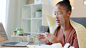 Female professional with covid or a cold isolating and quarantined alone while dealing with a work deadline. Young woman