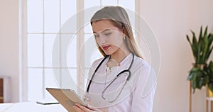 Female professional doctor wear white uniform holding using digital tablet