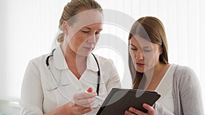 Female professional doctor at work. Woman physician with stethoscope consulting patient in clinic
