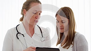 Female professional doctor at work. Woman physician with stethoscope consulting patient in clinic