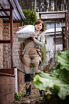 female professional gardener works in the garden