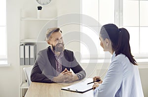 Female professional HR manager conducts interview with confident male job applicant.