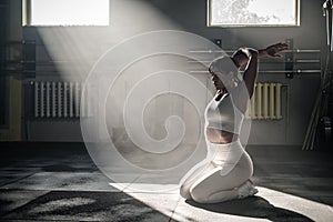 Female Professional Sportsman Stretch Her Arms and Shoulders .