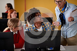 Female professor explaining an informatics lesson to the students