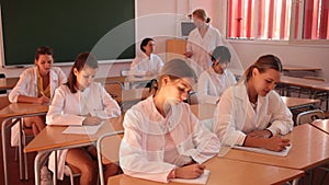 Female professor giving lesson for medical students in lecture hall