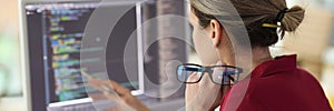 Female programmer checkups code working on computer