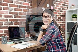 Female programmer sitting in working office