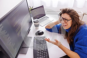 Female programmer stressed out while working overtime