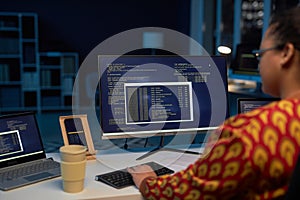 Female programmer typing computer codes on computer